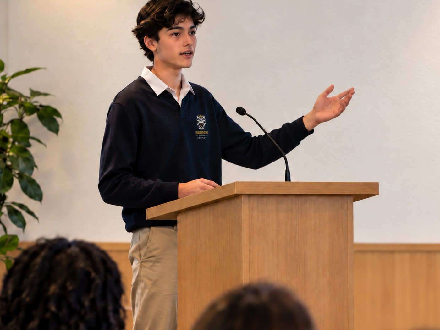 A student presenting a project to an audience at a showcase