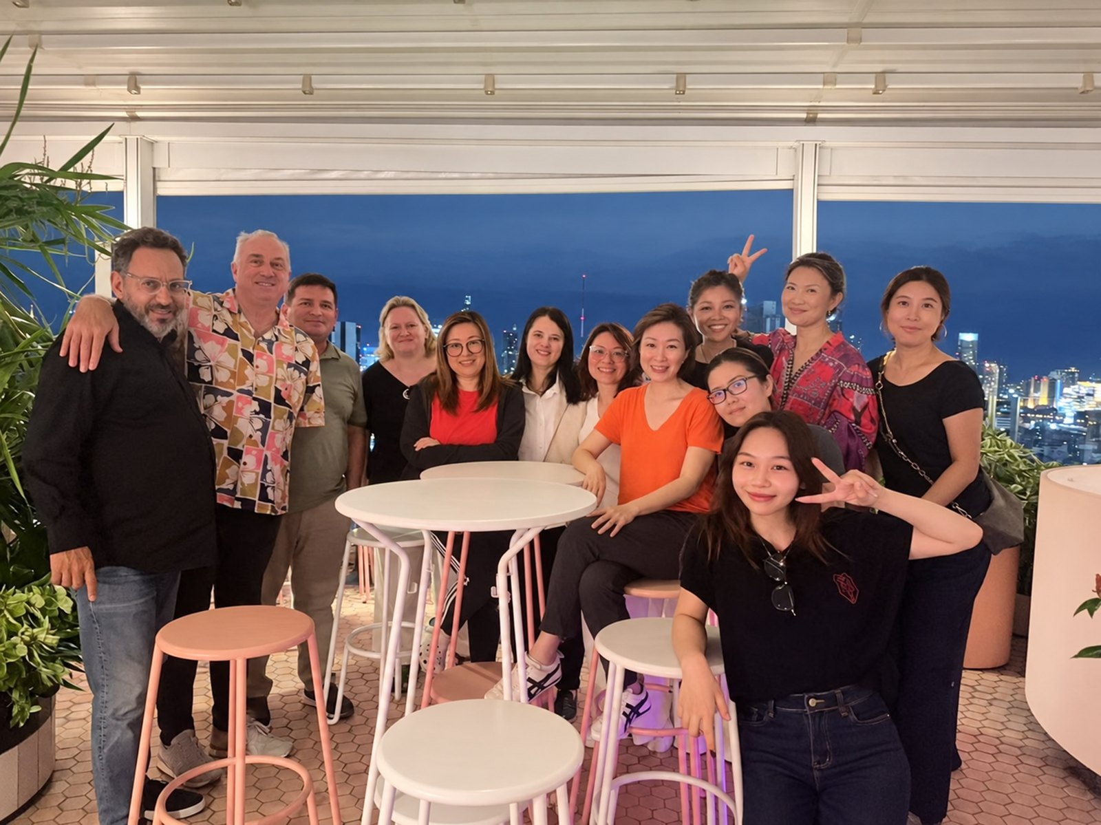 The CURIOO team together on a rooftop terrace at dusk